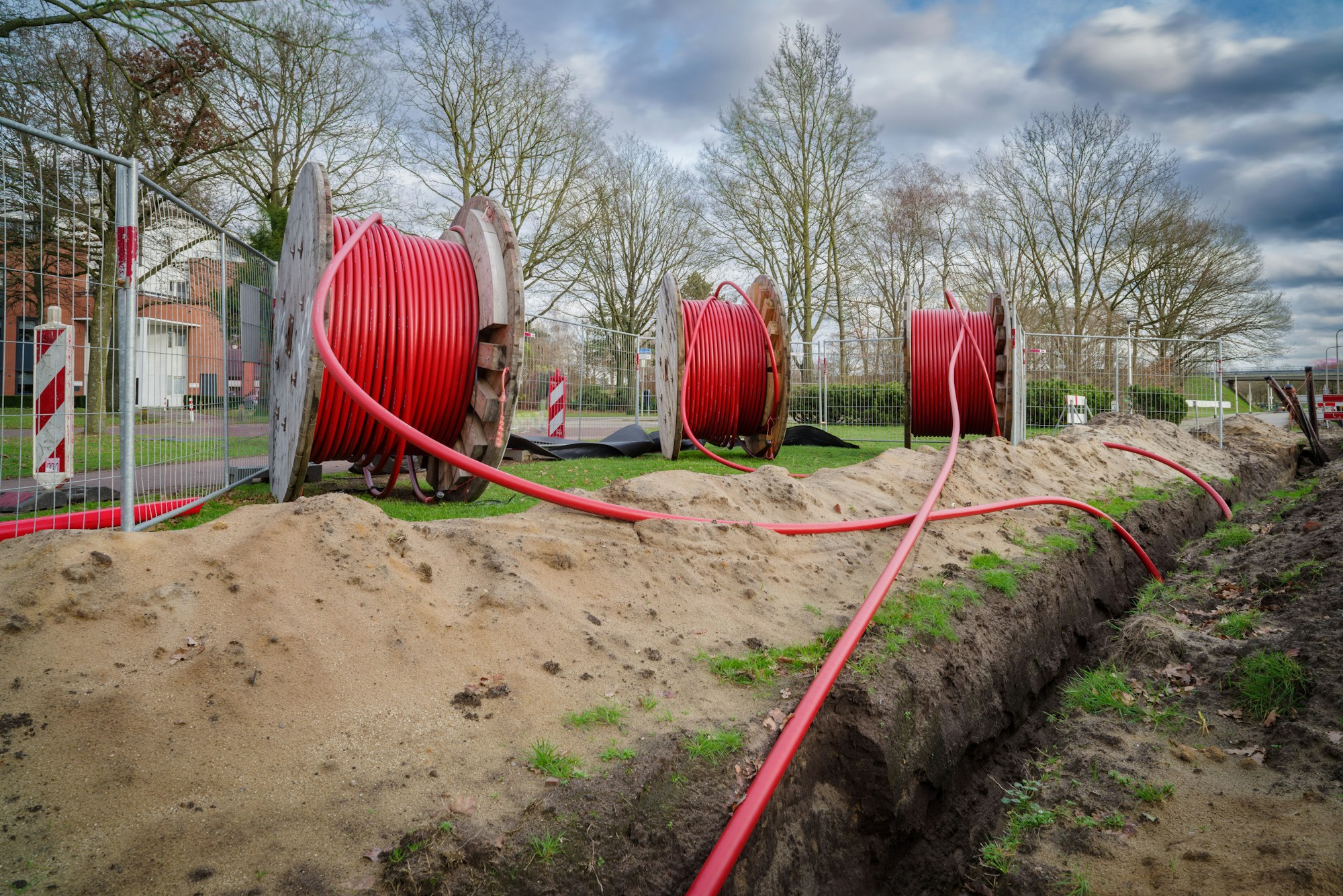 Three cable drums with fiber optic cables on it